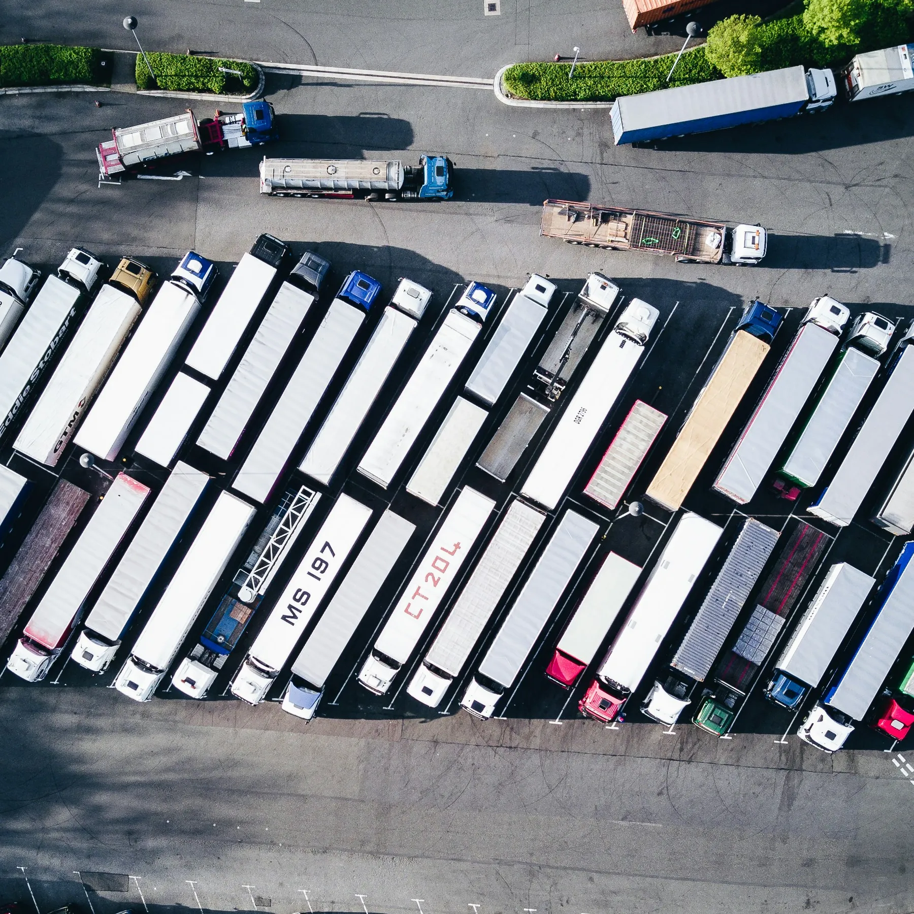 Aerial view of a yard full of parked trucks and trailers